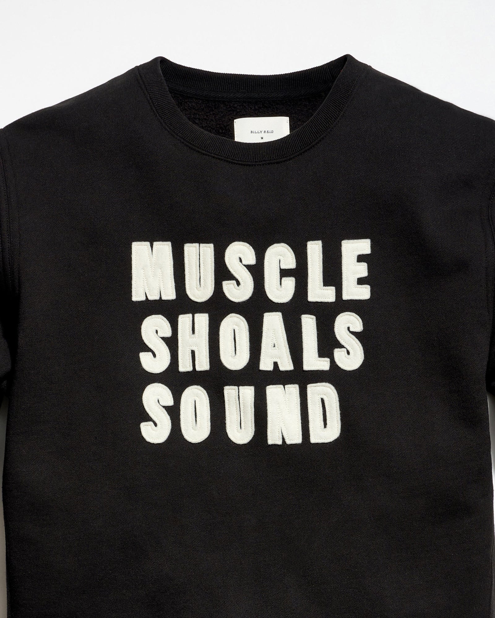 Black t-shirt with 'MUSCLE SHOALS SOUND' text on a white background