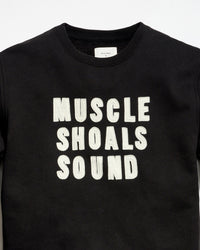 Black t-shirt with 'MUSCLE SHOALS SOUND' text on a white background