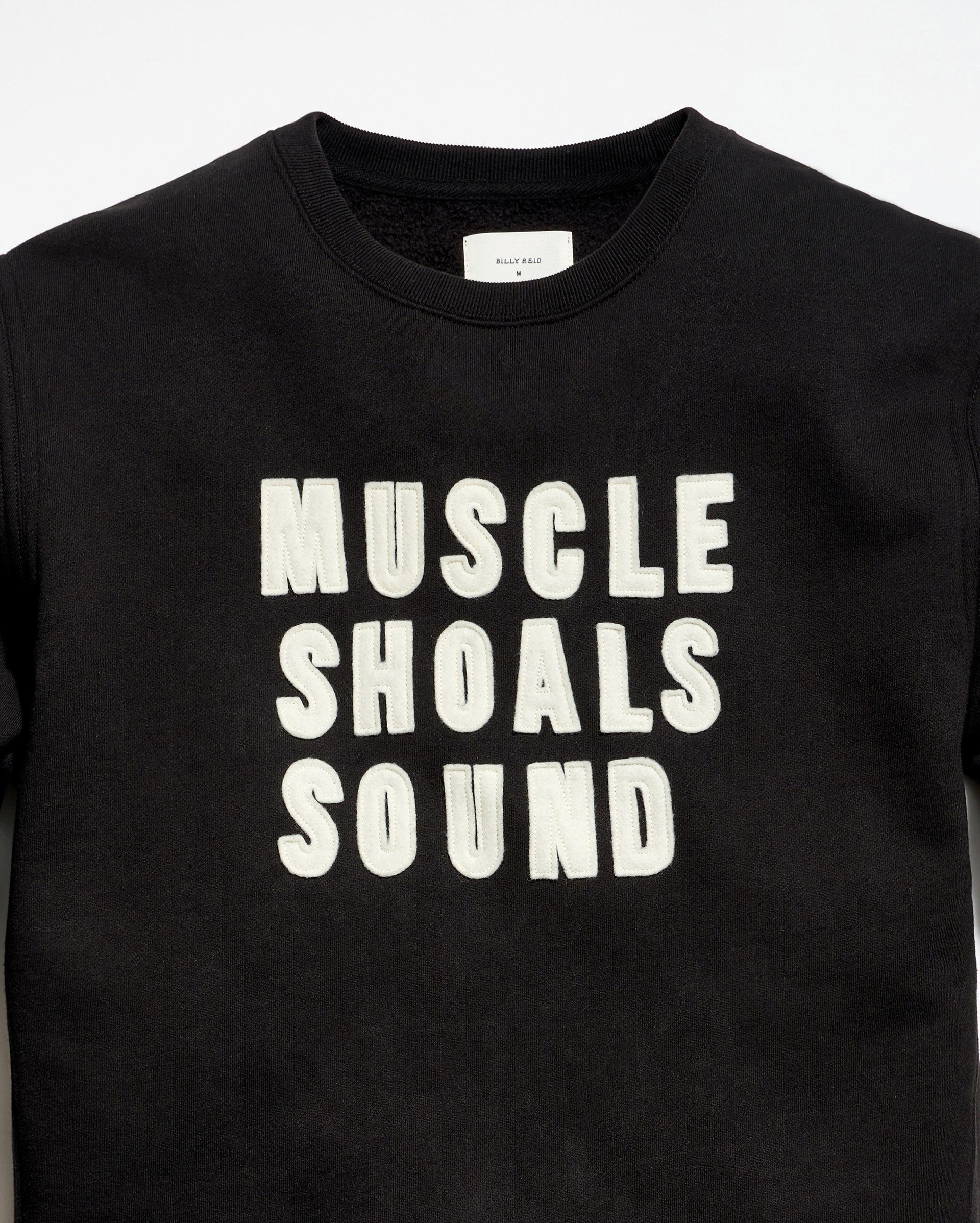 Black t-shirt with 'MUSCLE SHOALS SOUND' text on a white background