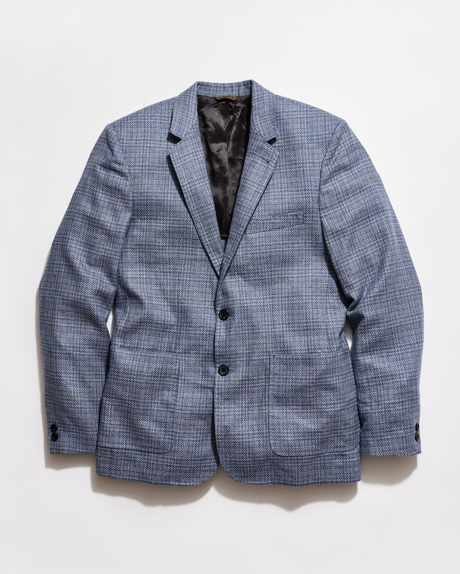 Blue checkered blazer on a light gray background