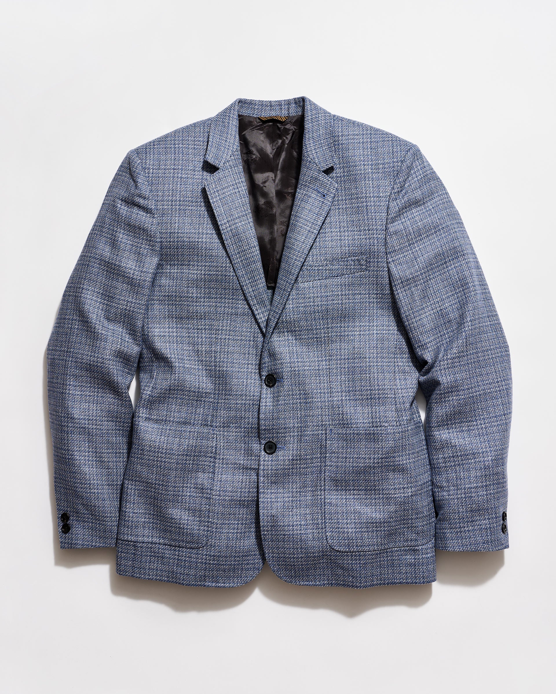 Blue checkered blazer on a light gray background