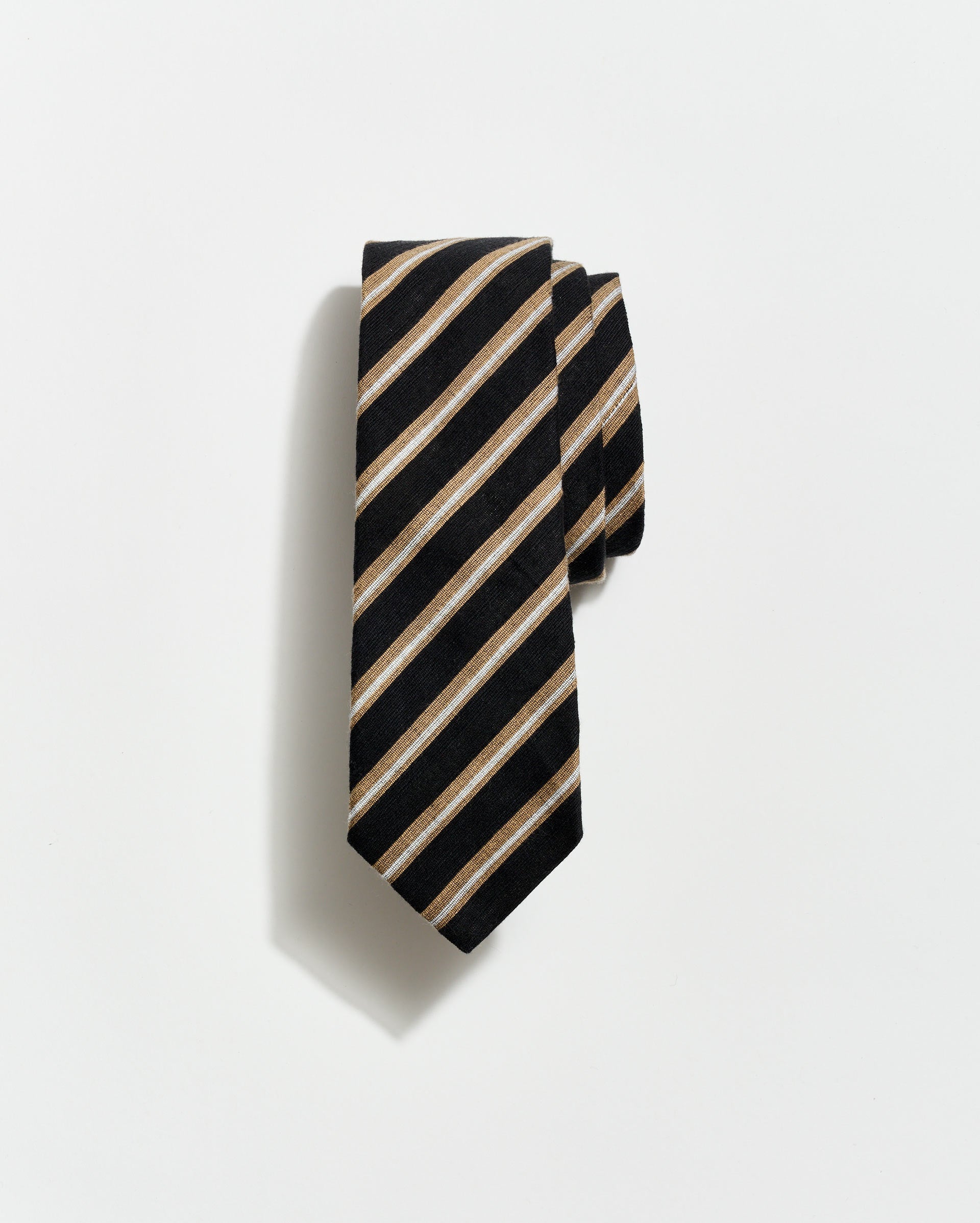 Black and beige striped tie on a light gray background