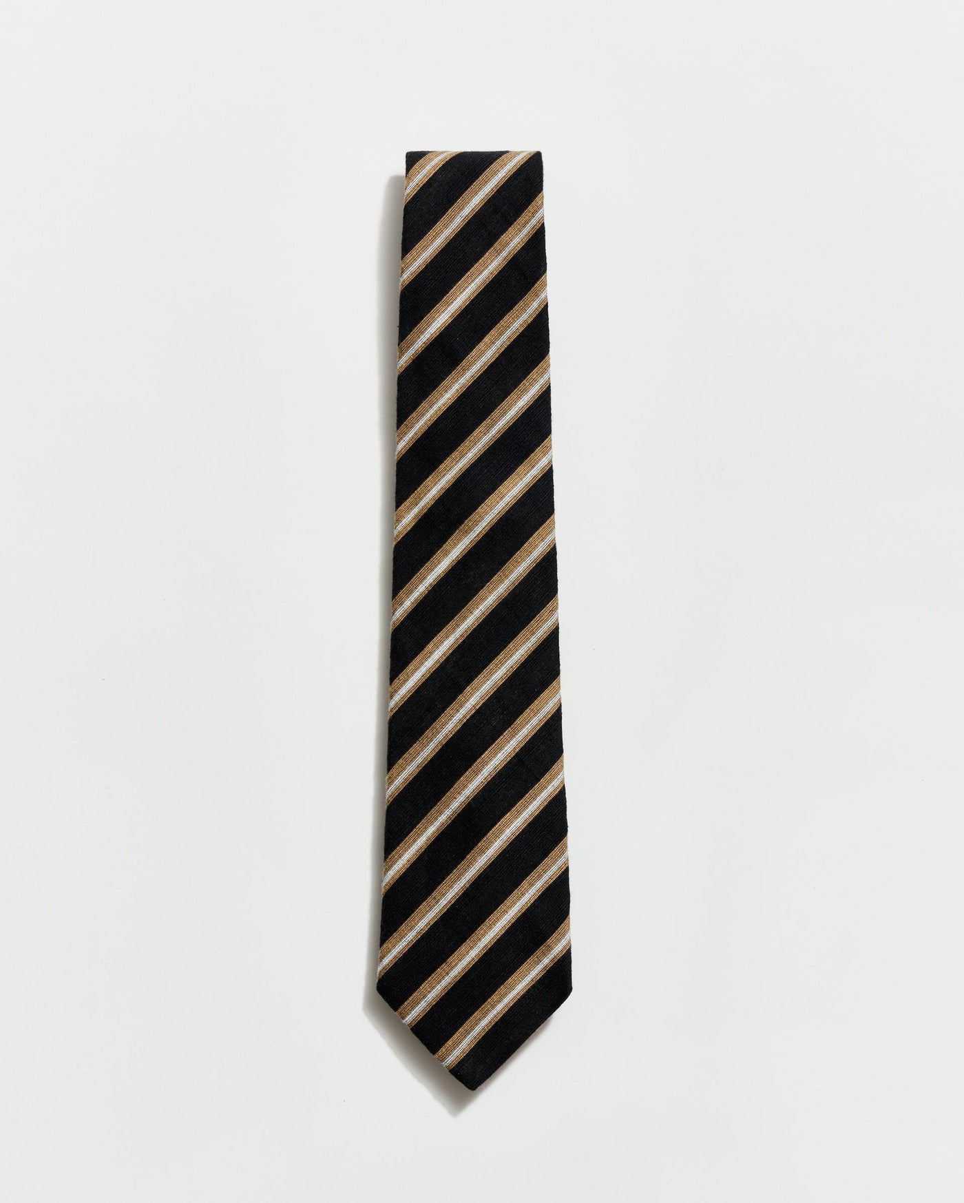 Black and beige striped tie on a light gray background