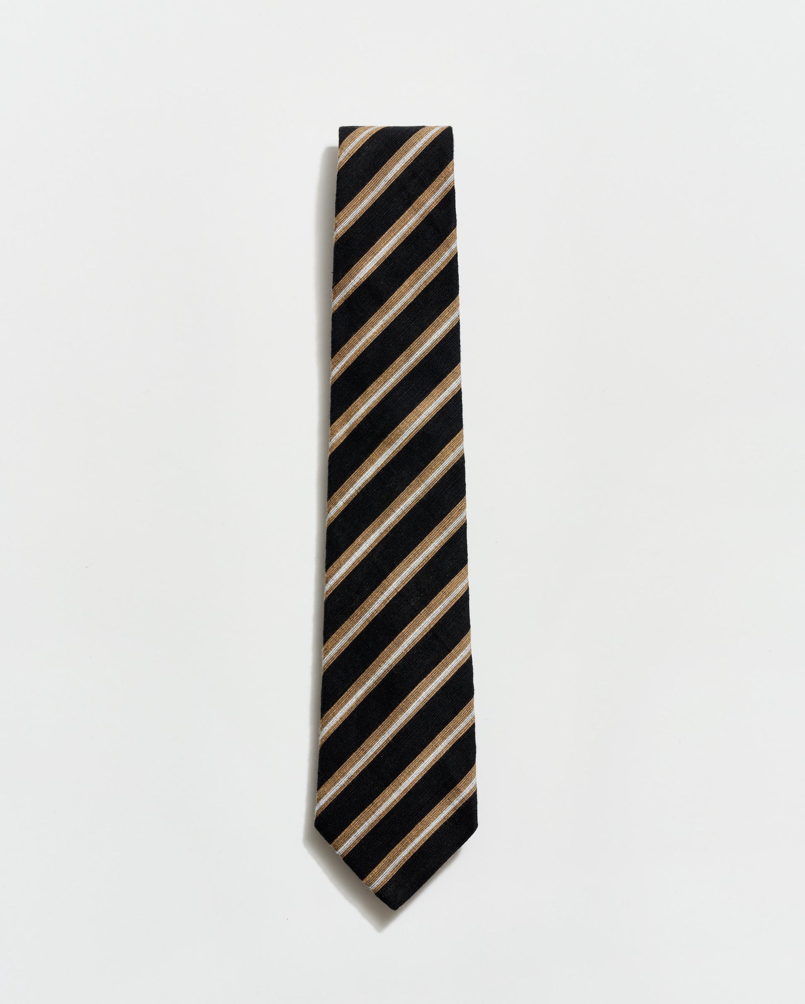 Black and beige striped tie on a light gray background