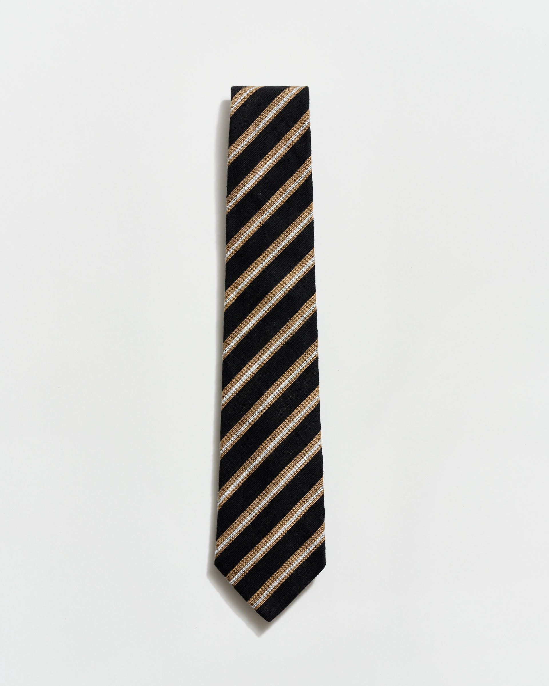 Black and beige striped tie on a light gray background