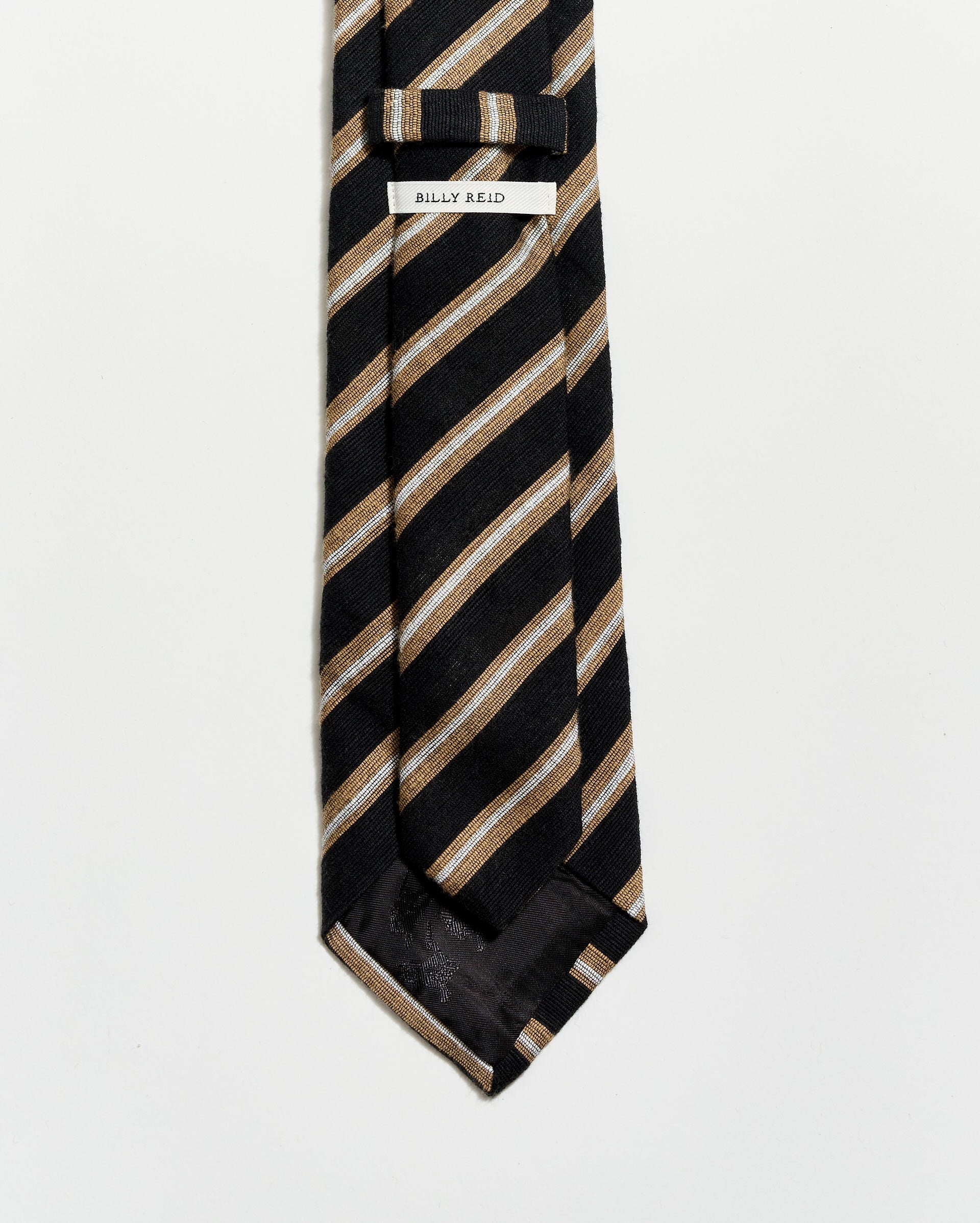 Black and beige striped tie with a 'BILLY Reid' label on a white background
