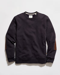 Black sweatshirt with brown elbow patches on a light gray background