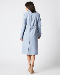 Female model wears the Macdougal Coat in Light Blue