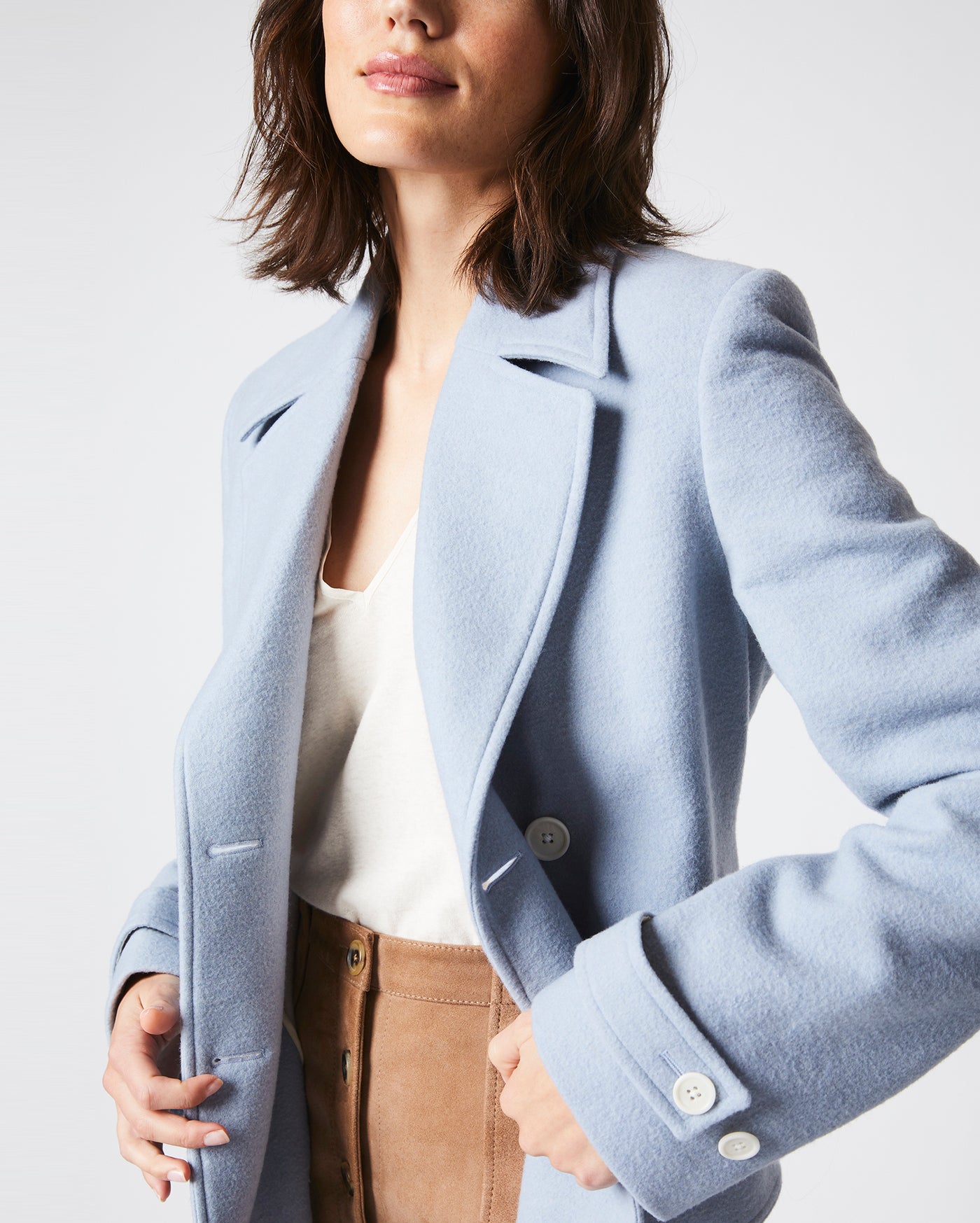 Female model wears the Macdougal Coat in Light Blue